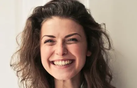 Woman smiling | Acknowledging employee achievements